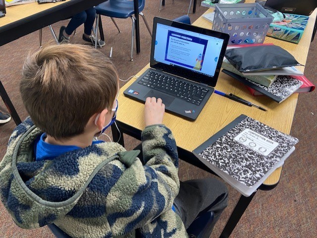 A 6th grader using NearPod to learn about the Earth's atmosphere.